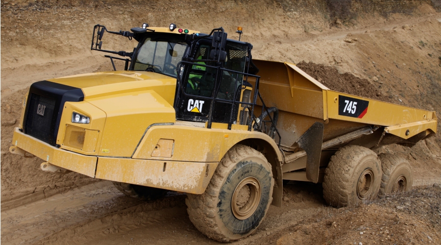 Cat 745 Articulated Truck climbs muddy ramp